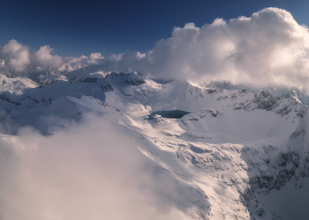 Schrecksee im Winterschlaf, Verschneite Hochalpenlandschaft mit Wolkentürmen, Drohnenfotografie Hinterstein