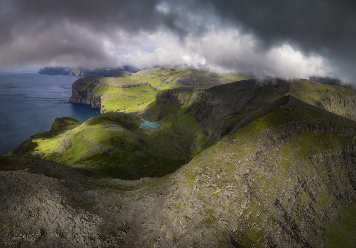 Färöer Bilder Faroe Islands Vágar Bergsee See Berge Klippen Meer Grün Wolken Blau